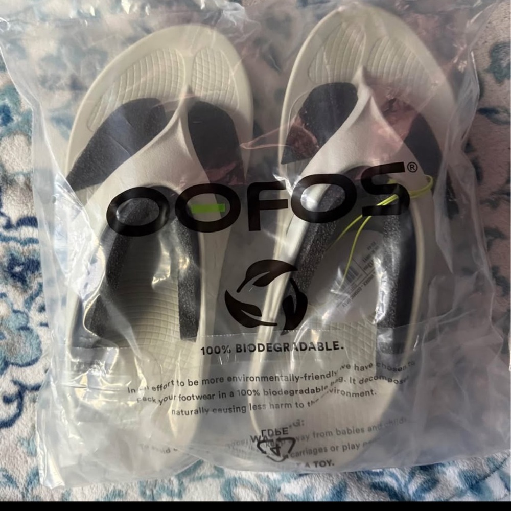 OOFOS Black and Cream Flip Flops